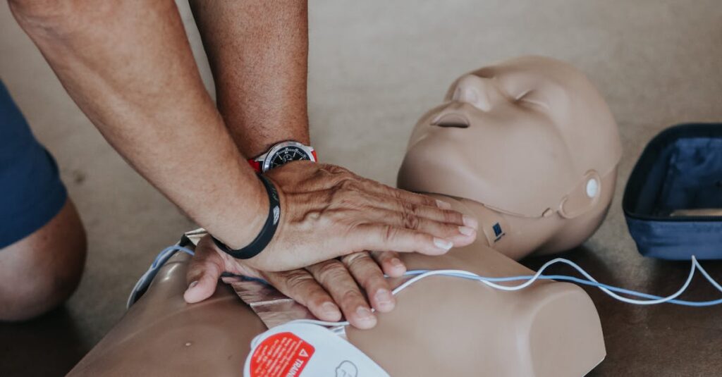 pexels-photo-11655091-11655091-2 Hands demonstrating CPR technique on a training mannequin with AED.