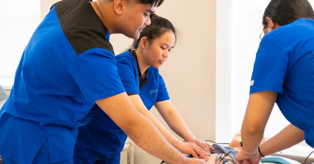 pexels-photo-35645530-35645530 Group of nursing students conducting a medical procedure in a training room.